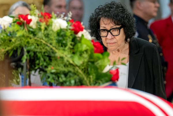 Supreme Court Justice Sonia Sotomayor pauses before the flag-draped casket of former President Jimmy Carter in the Capitol Rotunda on Wednesday.