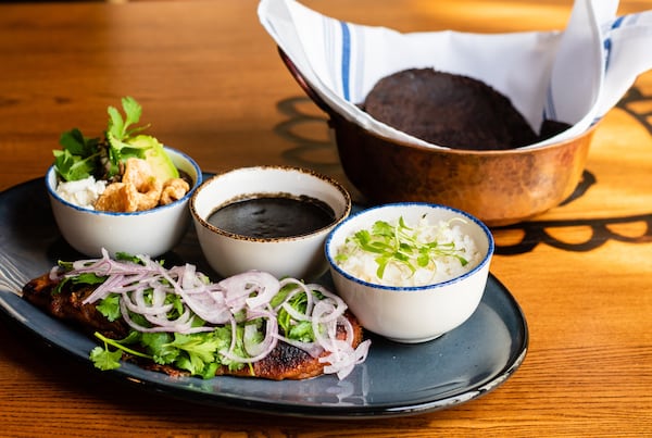 Pato con Mole Negro at Casi Cielo includes a large portion of fork-tender duck with beans, rice and black mole sauce for making tacos. CONTRIBUTED BY HENRI HOLLIS