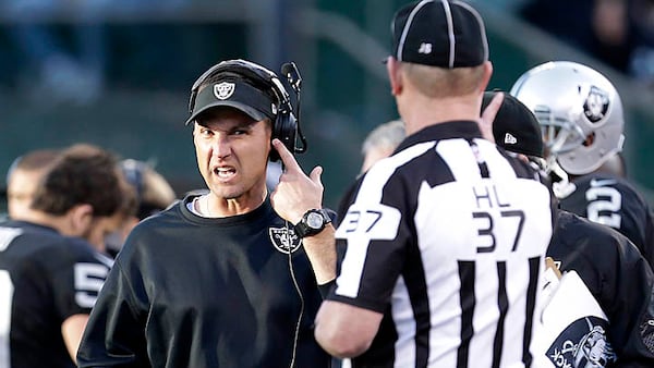 Oakland Raiders head coach Dennis, center left, Allen talks with head linesman Jim Howey (37) during the second half of an NFL football game against the Denver Broncos, Sunday, Dec. 29, 2013, in Oakland, Calif. (AP Photo/Tony Avelar)