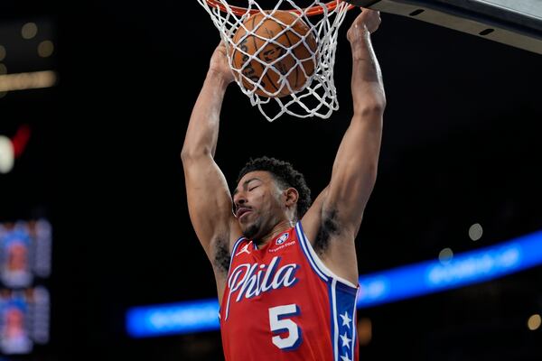 Philadelphia 76ers guard Quentin Grimes (5) dunks against the Atlanta Hawks during the first half of an NBA basketball game, Sunday, March 23, 2025, in Atlanta. (AP Photo/Mike Stewart)