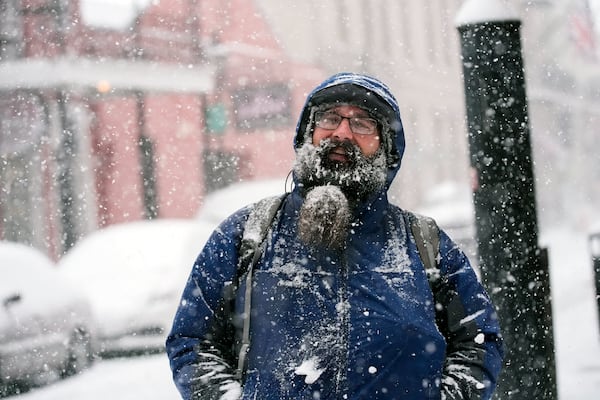 Johnathan Duval, visiting from Jacksonville, Fla., takes in the snow during a very rare snowstorm in the French Quarter of New Orleans, Tuesday, Jan. 21, 2025. (AP Photo/Gerald Herbert)