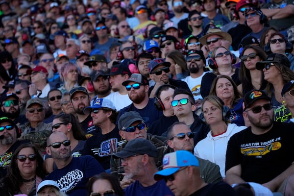 Fans watch during a NASCAR Cup Series Championship auto race at Phoenix Raceway, Sunday, Nov. 10, 2024, in Avondale, Ariz. (AP Photo/John Locher)