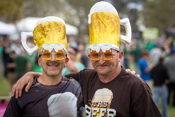 Justin Lester (L) and Scott George show of there beer fest hats at the Suwanee Beer Fest in Suwanee. STEVE SCHAEFER / SPECIAL TO THE AJC