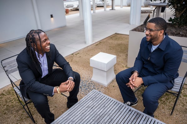 The Gathering Spot Co-Founder and CFO TK Petersen, left, and Co-founder and CEO Ryan Wilson, right, talk at their second Atlanta location at the Interlock in West Midtown, transforming a former WeWork space and rooftop restaurant into a new hub for community and collaboration. (Olivia Bowdoin for the Atlanta Journal-Constitution). 