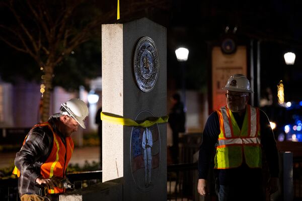 A crew works to remove a Confederate monument from its place on the grounds of the Gwinnett Historic Courthouse in Lawrenceville, Ga., on Thursday, Feb. 4, 2021. The Gwinnett County Board of Commissioners voted unanimously on January 19 to remove the monument, overturning the decision of their predecessors from almost three decades prior. In 1993, county commissioners gave permission for the monument to be installed at the request of the United Daughters of the Confederacy. (Casey Sykes for The Atlanta Journal-Constitution)