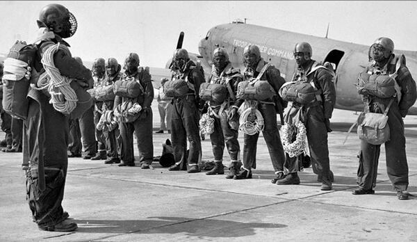 Members of the 555th Parachute Infantry Battalion at Pendleton Army Airfield getting briefed before taking off to drop on a wildfire in the summer of 1945. (National Archives via Eastern Washington University)