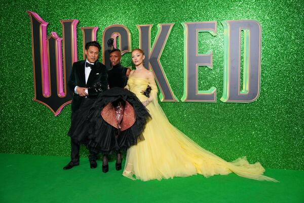 Director Jon M. Chu, from left, Cynthia Erivo and Ariana Grande pose for photographers upon arrival at the premiere of the film 'Wicked' on Monday, Nov. 18, 2024, in London. (Photo by Scott A Garfitt/Invision/AP)