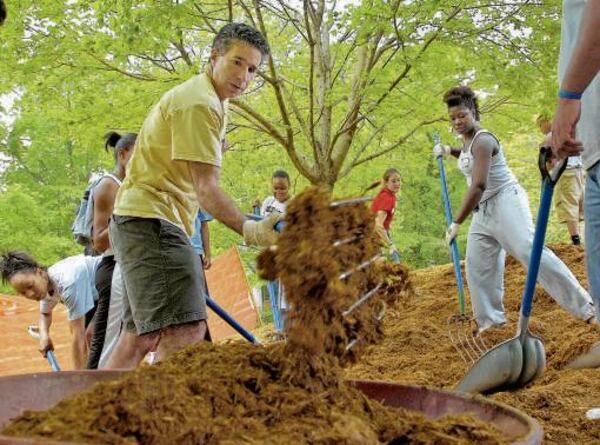 Larry Schall (in yellow) has taken hands-on approach as president of Oglethorpe University. Applications to the small liberal arts college in Brookhaven have quadrupled since he's taken over in 2005.