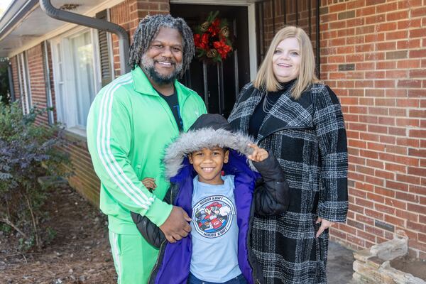 Michael Glenn and his son MJ pose with his Open Doors case navigator Jennifer Yearwood at Glenn's Decatur home. Open Doors, a nonprofit focused on securing housing for those in need, worked with Glenn using the Home Depot Foundation grant. The Home Depot funds are specifically used to provide permanent and sustainable housing for veterans. PHIL SKINNER FOR THE ATLANTA JOURNAL-CONSTITUTION
