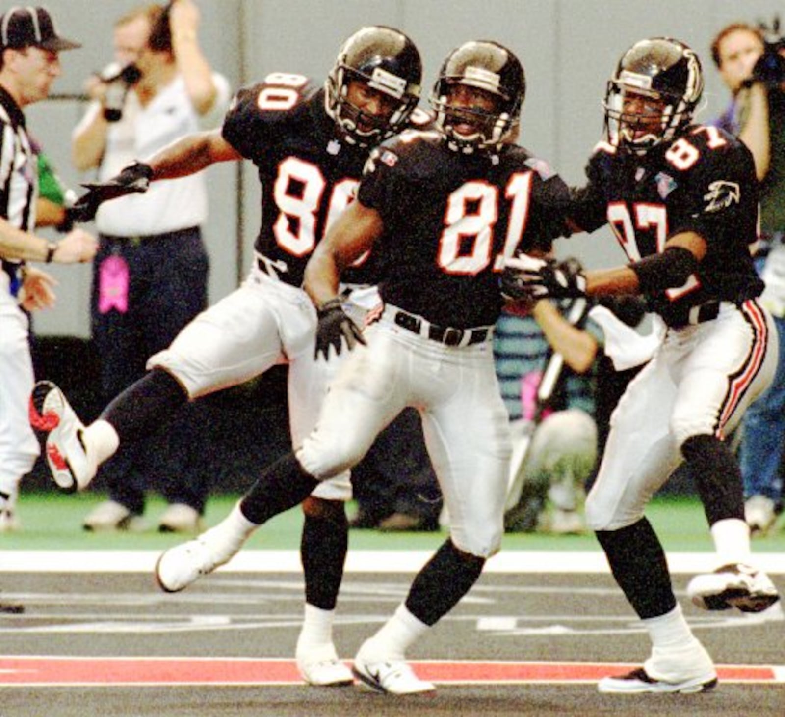 Receivers Andre Rison (80), Terance Mathis (81) and Bert Emanuel celebrate a score in 1994.