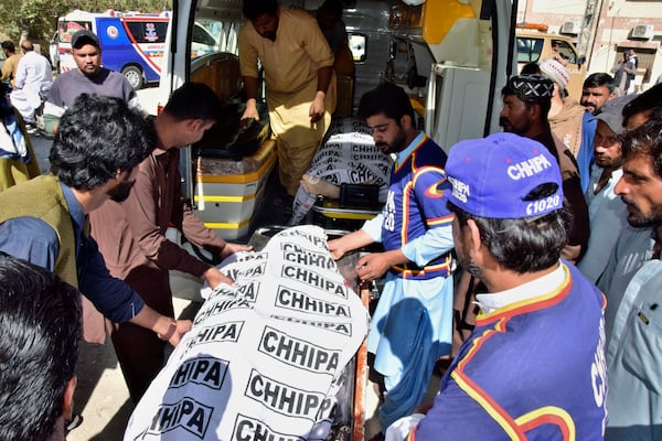 Volunteers and relatives load bodies of victims of a bomb explosion at railway station, into an ambulance after receiving from a hospital, in Quetta, southwestern Pakistan, Saturday, Nov. 9, 2024. (AP Photo/Arshad Butt)