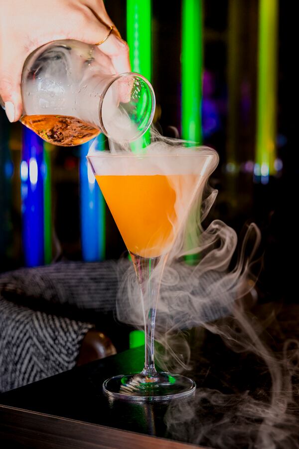 Puttshack's signature cocktail is the vanilla and passion fruit-laden porn star martini, poured with smoky flair. Courtesy of Puttshack