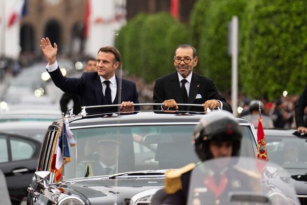 Morocco's king Mohammed VI, right, and French president Emmanuel Macron wave to crowds during the latter's official visit to Morocco, in the capital Rabat, Monday, Oct. 28, 2024. (AP Photo/Mosa'ab Elshamy)