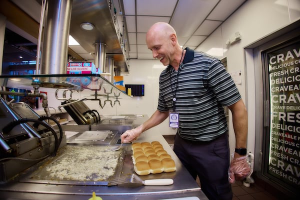 Marietta resident Ken Oberle prepares sliders at the White Castle Cravers Hall of Fame induction festivities in May. One of Oberle's first jobs was working at White Castle, and he has been a fan of the burger joint his entire life. Courtesy of White Castle