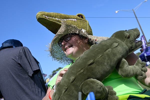 Annie Polen, of Tampa, Fla., wears a homemade alligator hat and a stuffed alligator purse while attending the Florida Man Games, Saturday, March 1, 2025, in Elkton, Fla. (AP Photo/Phelan M. Ebenhack)