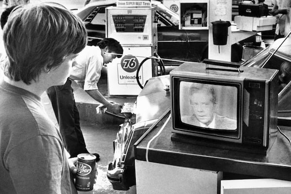 A college student watches President Jimmy Carter's nationally televised energy speech on July 15, 1979, from a service station in Los Angeles, as a gas station attendant fills up a customer's car. Known as the "malaise" speech, it warned that a "crisis of confidence" that posed a fundamental threat to U.S. democracy. (AP file)