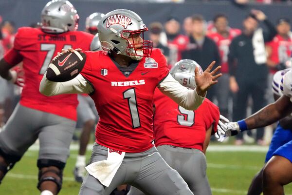 UNLV quarterback Jayden Maiava (1) throws down field against Kansas during the first half of the Guaranteed Rate Bowl NCAA college football game Tuesday, Dec. 26, 2023, in Phoenix. (AP Photo/Rick Scuteri)