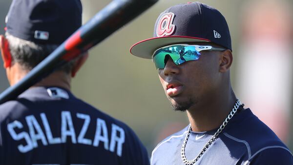 Braves outfield prospect Ronald Acuna gets some pointers from coach Luis Salazar on Friday, Feb 16, 2018.