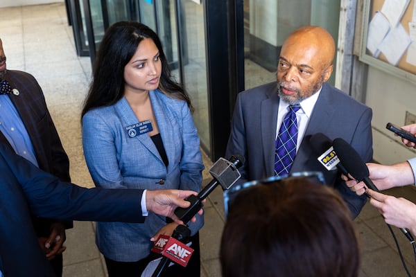 Democratic state Sen. Nabilah Islam Parkes and her attorney, Wayne Kendall, speak to the news media after a Fulton County judge dismissed a lawsuit by Democrats who wanted the governor to investigate the State Elections Board.