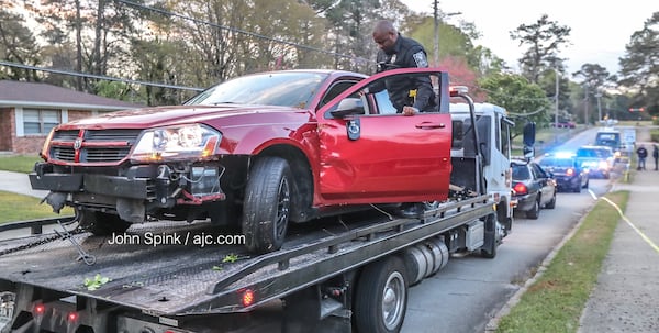 DeKalb County police are ready to tow a car after a road-rage shooting on Atherton Drive that reportedly stemmed from a domestic dispute. JOHN SPINK / JSPINK@AJC.COM