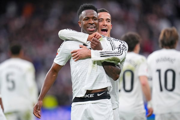 Real Madrid's Vinicius Junior celebrates with Real Madrid's Lucas Vazquez after scoring his side's second goal during the Spanish La Liga soccer match between Real Madrid and Rayo Vallecano at the Santiago Bernabeu stadium in Madrid, Spain, Sunday, March 9, 2025. (AP Photo/Manu Fernandez)