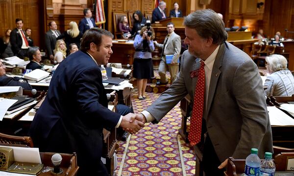 Chairman of the house transportation committee, Rep. Jay Roberts, left, and Rep. Terry England, a co-sponsor of HB 170, celebrate the house passage of the $900 million transportation funding bill.  (BRANT SANDERLIN / BSANDERLIN@AJC.COM)