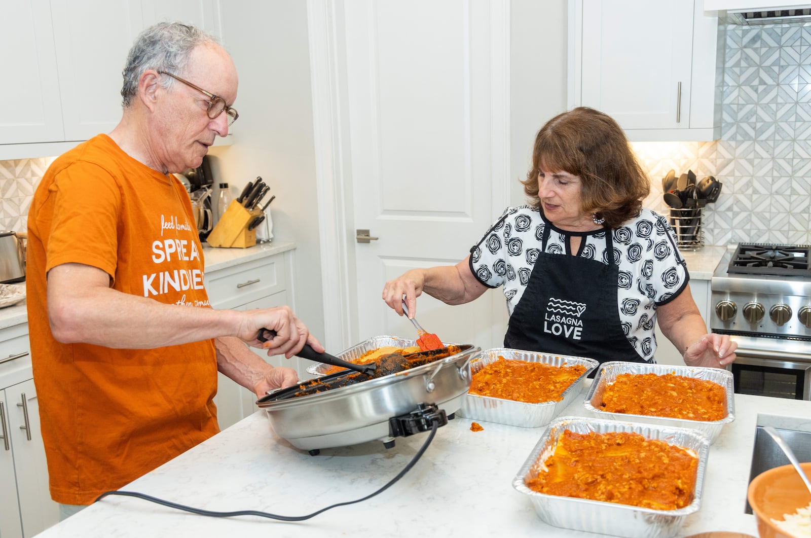 The Hirsches make four pans of lasagna in their Alpharetta home. PHIL SKINNER FOR THE ATLANTA JOURNAL-CONSTITUTION