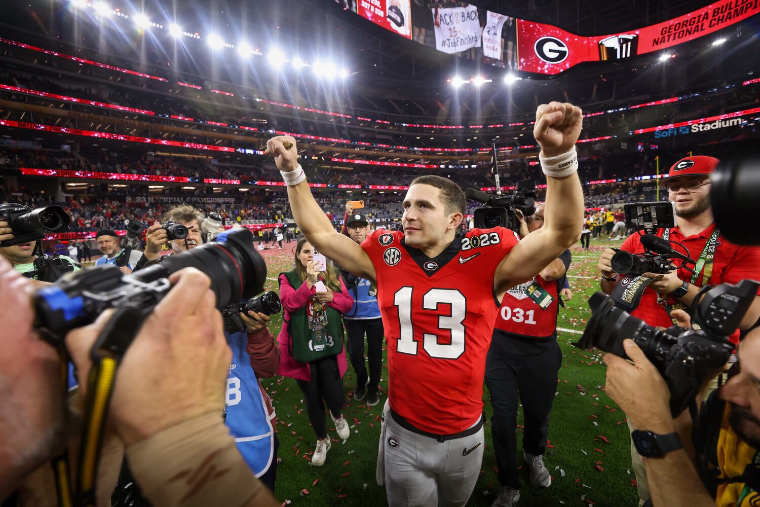 Georgia Bulldogs quarterback and offensive most valuable player Stetson Bennett (13) celebrates after defeating the TCU Horned Frogs 65-7 in the College Football Playoff National Championship at SoFi Stadium in Los Angeles on Monday, January 9, 2023 to secure a second consecutive national title. (Jason Getz / Jason.Getz@ajc.com)