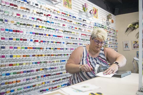 Labors of Love Needlepoint operations manager Audra Deaughtry finishes orders at the store in Atlanta’s Morningside-Lenox Park neighborhood, Friday, April 10, 2020. (ALYSSA POINTER / ALYSSA.POINTER@AJC.COM)