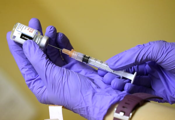 RN Courtney Kirkland prepares a Moderna COVID-19 vaccination at the Paulding County Health Department on Tuesday. Inoculations are hovering around 30% among workers in many health care facilities, particularly outside metro Atlanta, state health officials say they have been told. (Curtis Compton / Curtis.Compton@ajc.com)