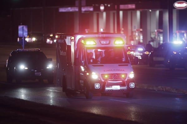 An ambulance leaves the scene of a shooting at a gas station in Springfield, Mo., late Sunday, March 15, 2020. Police Chief Paul Williams said Monday morning, a Springfield police officer was killed. (Nathan Papes/The Springfield News-Leader via AP)