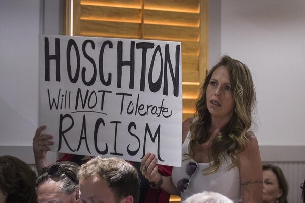 Hoschton resident Kelly Winebarger protests for the resignation of Hoschton Mayor Theresa Kenerly and Councilman Jim Cleveland at the Hoschton Historic Train Depot in Hoschton, Monday, May 6, 2019. “I don’t want people the think that about our community,” Kelly said as she referenced the controversy concerning the mayor of Hoschton allegedly pulling the resume of Keith Henry from a packet of four finalists for a city position, “because he is black, and the city isn’t ready for this.” ALYSSA POINTER / ALYSSA.POINTER@AJC.COM