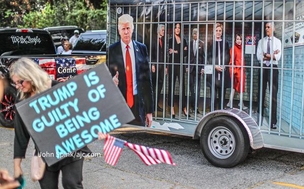 Law enforcement, national and local news outlets and former  President Donald Trump supporters wait outside the Fulton County Jail on Thursday ahead of the former president's surrender. (John Spink / John.Spink@ajc.com )