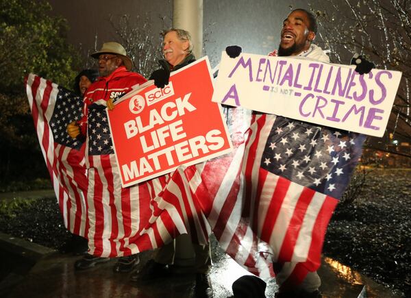 Protesters in Decatur celebrate after hearing about the grand jury indictment of former DeKalb County police officer Robert Olsen on January 21, 2016, in the shooting death of Anthony Hill. (photo: Ben Gray / AJC file)