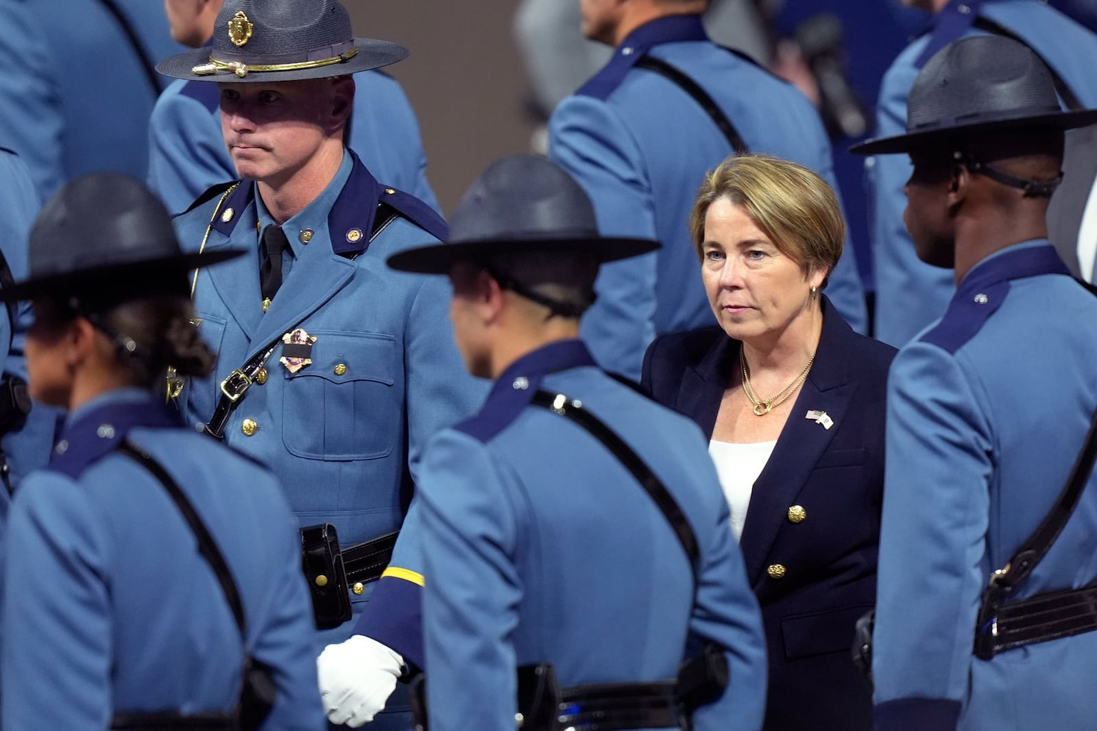 Massachusetts Gov. Maura Healey, right, walks among members of the 90th Recruit Training Group of the Massachusetts State Police, Wednesday, Oct. 9, 2024, during swearing in ceremonies at the DCU Center, in Worcester, Mass. (AP Photo/Steven Senne)