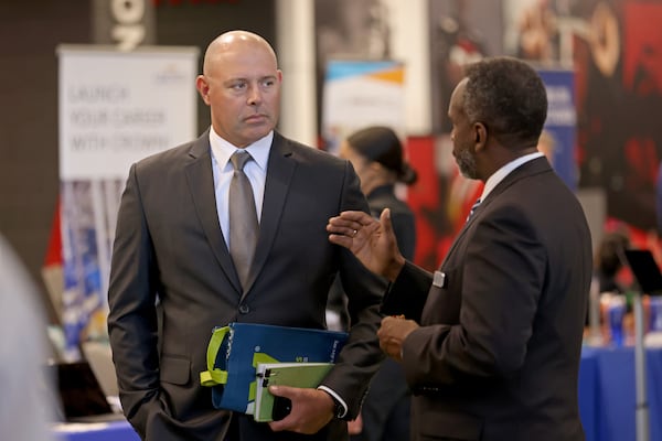 Army veteran Aaron Poulin, left, speaks with Bill Tanks, of the City of Powder Springs public services, during a Veterans Job Fair at Mercedes-Benz Stadium, Thursday, September 29, 2022, in Atlanta. Around 300 veterans met with over 60 organizations at this job fair hosted by DAV and Recruit Military. (Jason Getz / Jason.Getz@ajc.com)