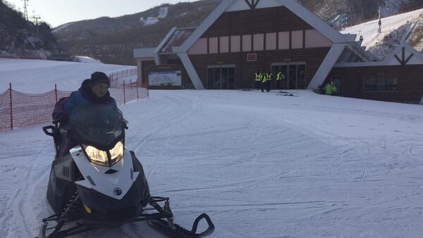 An imported snowmobile comes back from the top of a ski run at the Masik Pass ski resort in North Korea Sunday, Jan. 28, 2018. Despite international sanctions on luxury goods, the showcase resort built at the order of North Korean leader Kim Jong Un in 2013 has everything from ski boots to ski lifts brought in from around the world. The resort is coming under increased attention ahead of its first joint training with skiers from South Korea ahead of the Pyeongchang Olympics. (AP Photo/Eric Talmadge)