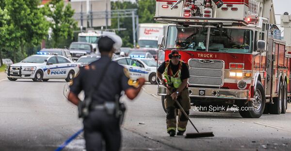 Emergency responders work to clear a crash on I-85 North at Riverdale Road that temporarily shut down all lanes of the interstate. JOHN SPINK / JSPINK@AJC.COM