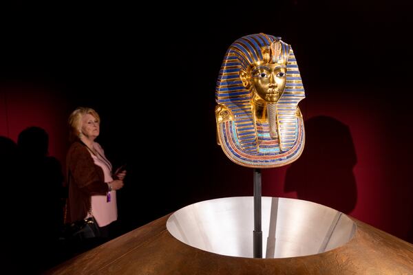 A visitor attends the “Tutankhamun: His Tomb and His Treasures” exhibit at Exhibition Arts Center Atlanta in Doraville on Wednesday, October 4, 2023. (Arvin Temkar / arvin.temkar@ajc.com)