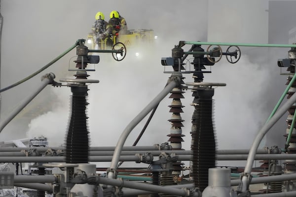 Firefighters extinguish the fire at the North Hyde electrical substation, which caught fire Thursday night and led to a closure of Heathrow Airport in London, Friday, March 21, 2025.(AP Photo/Kirsty Wigglesworth)