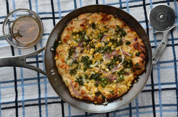 You can enjoy Cheesy Corn, Ranch and Jalapeno Pizza even more by serving honey mixed with freshly ground black pepper for drizzling or dipping. (Styling by Susan Puckett / Chris Hunt for the AJC)