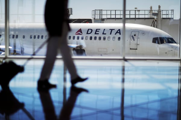 FILE - In this Oct. 13, 2016, file photo, a Delta Air Lines jet sits at a gate at Hartsfield-Jackson Atlanta International Airport in Atlanta. Delta said it supports a proposed ban on plastics at the airport. (AP Photo/David Goldman, File)