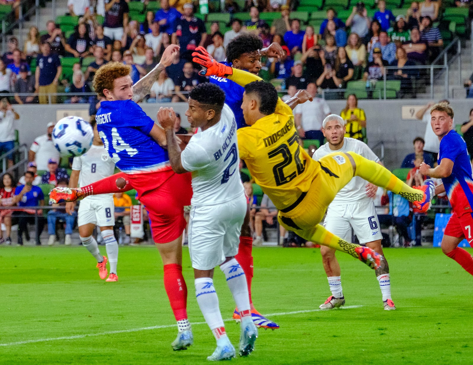 United States forward Josh Sargent (24) collides with Panama goalkeeper Orlando Mosquera (22) and defender Cesar Blackman (2) on a corner kick during the first half of an international friendly soccer match, Saturday, Oct. 12, 2024, in Austin, Texas. (AP Photo/Rodolfo Gonzalez)