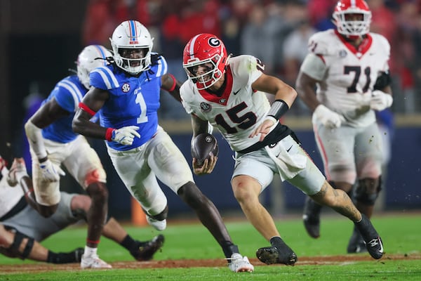 Georgia quarterback Carson Beck (15) runs for yards against Mississippi defensive end Princely Umanmielen (1) during the fourth quarter at Vaught Hemingway Stadium, Saturday, November 9, 2024, in Oxford, Ms. Mississippi won 28-10. (Jason Getz / AJC)
