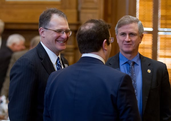 State Sen. William Ligon, left, is congratulated after Senate Bill 375 won the Georgia Senate’s approval Friday. The bill would allow adoption agencies to refuse to place children with same-sex families. STEVE SCHAEFER / SPECIAL TO THE AJC