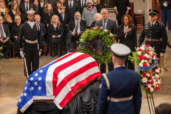 Vice President Kamala Harris and Second Gentleman Doug Emhoff pay their respects as former President Jimmy Carter lies in state inside the rotunda of the U.S. Capitol.