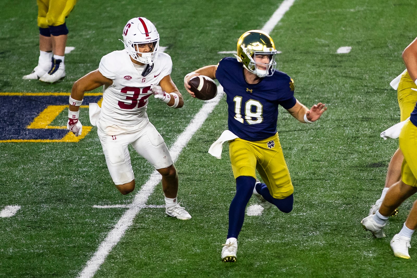 Notre Dame quarterback Steve Angeli (18) runs the ball as Stanford safety Mitch Leigber (32) pursues during the second half of an NCAA college football game Saturday, Oct. 12, 2024, in South Bend, Ind. (AP Photo/Michael Caterina)