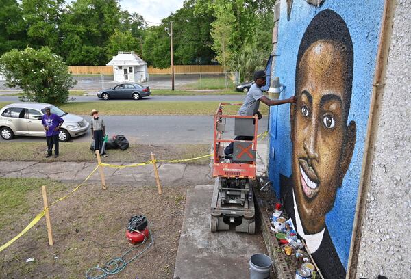 Miami-based artist Marvin Weeks works on a large mural in tribute to Ahmaud Arbery in 2020. 