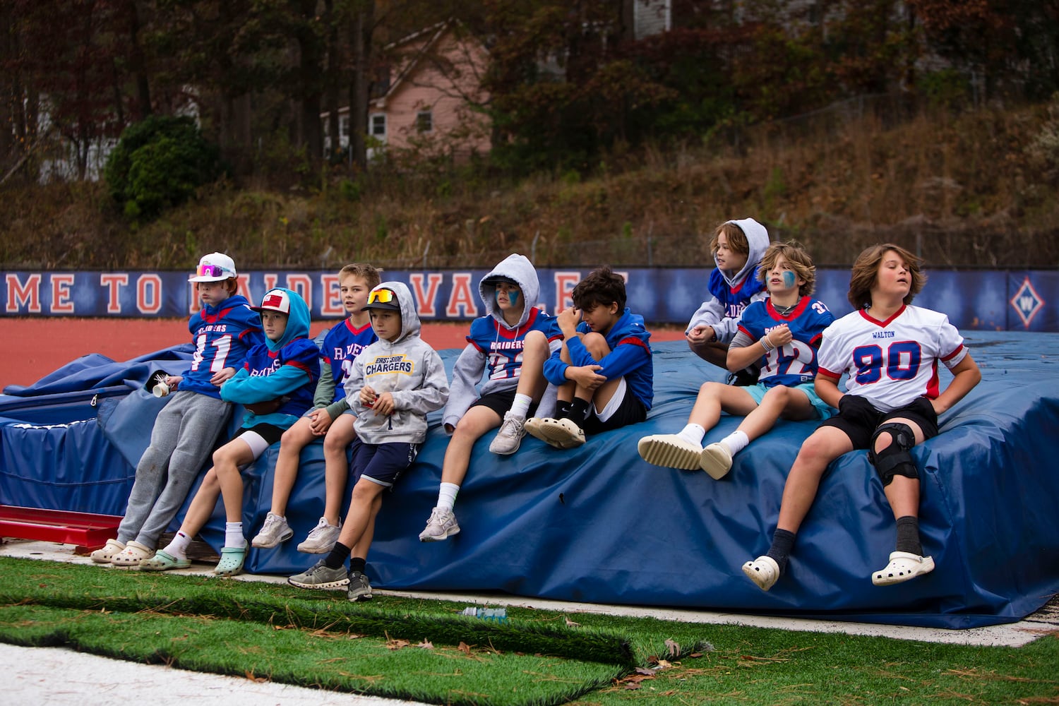 Young Walton football team fans sit on the sidelines. CHRISTINA MATACOTTA FOR THE ATLANTA JOURNAL-CONSTITUTION.