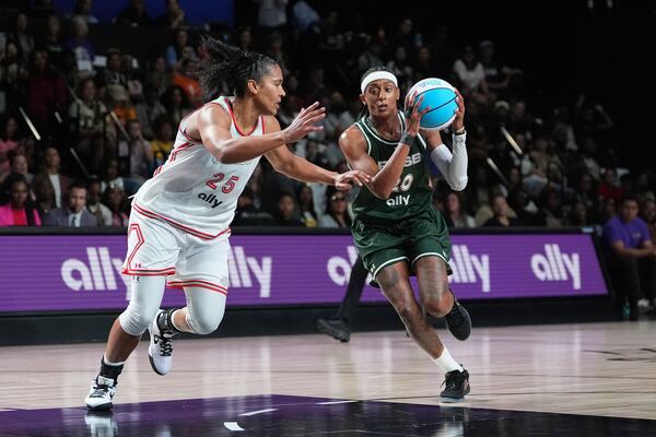 Rose guard Brittney Sykes (20) drives for the basket defended by Laces forward Alyssa Thomas (25) in their Unrivaled 3-on-3 basketball semifinal, Sunday, March 16, 2025, in Medley, Fla. (AP Photo/Rebecca Blackwell)